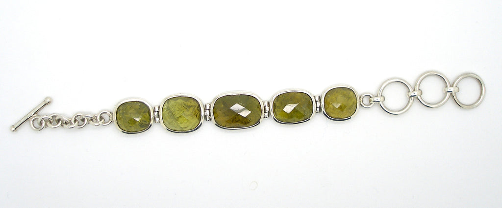 5 large faceted Grossular Garnets, Besel set, hinged together to make a very different Bracelet | These rare Garnets are Green, the name comes from the Latin for Gooseberry | Adjustable length up to 180 mm | Crystal Heart Melbourne since 1986