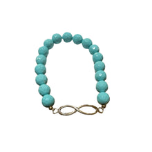 Load image into Gallery viewer, Turquoise beaded bracelet with an infinity charm on a textured surface
