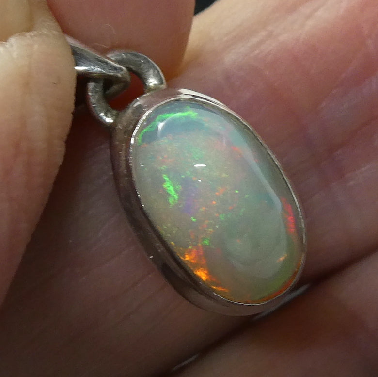 Ethiopian Opal Pendant | Oval Cabochon | Green red blueFlashes | Simple Bezel Setting | Open Back | | 925 Silver | Genuine Gems from Crystal Heart Australia since 1986