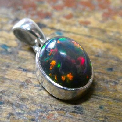 Black Opal Pendant | Ethiopian | Oval | Green Red Flashes | Simple Bezel Setting | Open Back | | 925 Silver | Genuine Gems from Crystal Heart Australia 1986