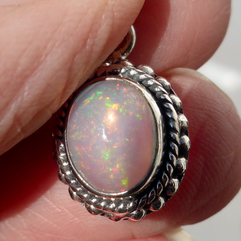 Ethiopian Solid Opal Pendant | Small Oval Cabochon | Green & Red Flash | 925 Silver | Bezel Setting with 3 layers of ornamentation surrounding | Open Back | Genuine Gems from Crystal Heart Australia since 1986