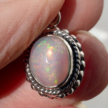 Load image into Gallery viewer, Ethiopian Solid Opal Pendant | Small Oval Cabochon | Green &amp; Red Flash | 925 Silver | Bezel Setting with 3 layers of ornamentation surrounding | Open Back | Genuine Gems from Crystal Heart Australia since 1986